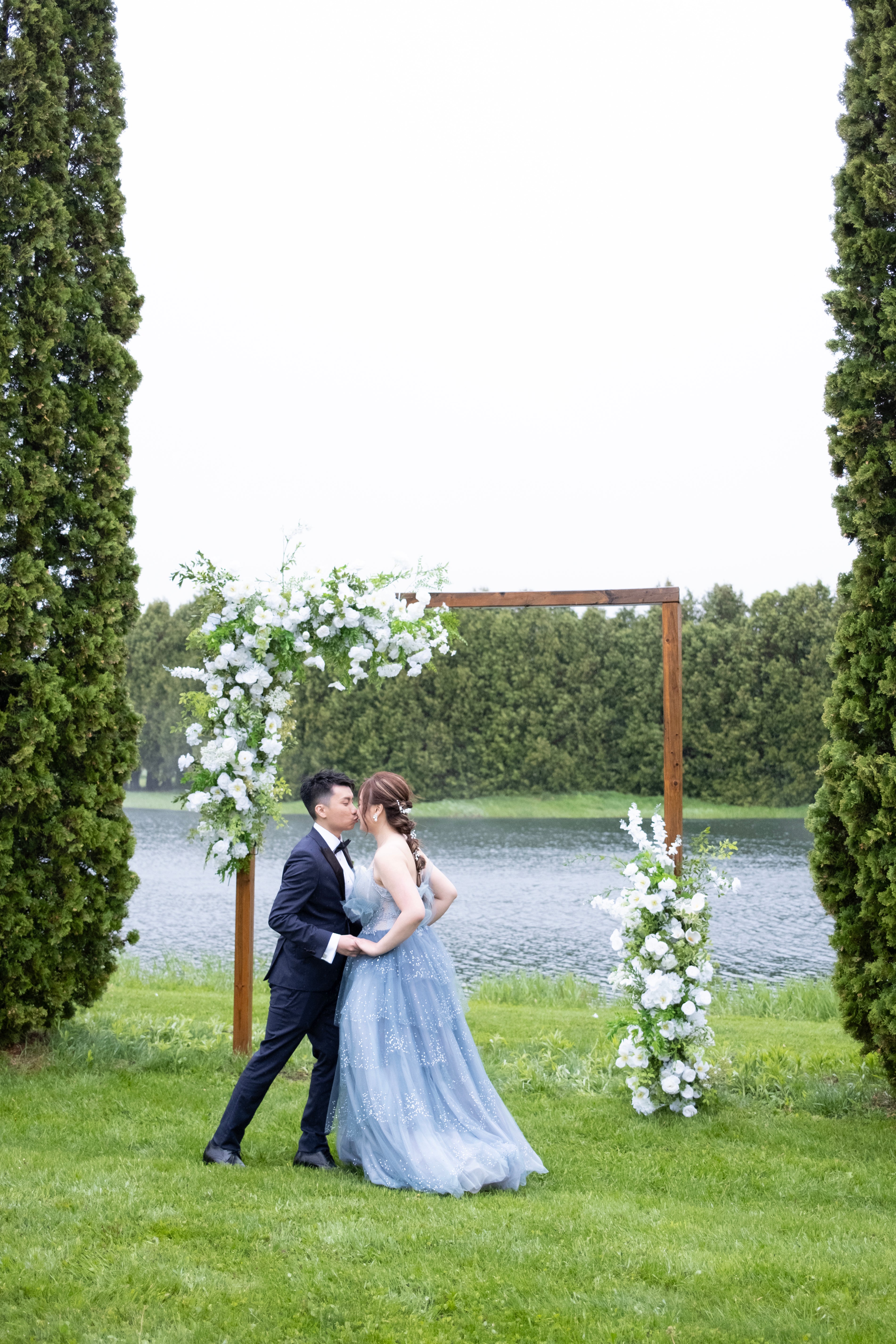 White & Green Ceremony with Wooden Arch